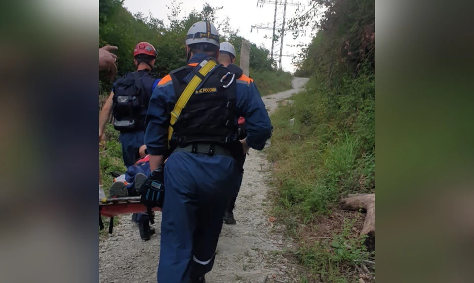 Спасатели нашли пострадавшую в ущелье и доставили на носилках к машине скорой помощи / Фото: ЮРПСО МЧС России